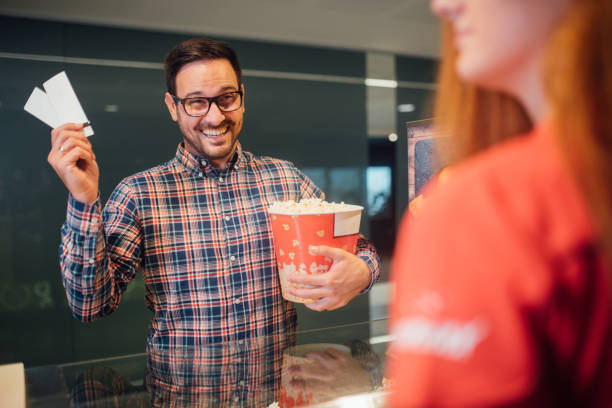 istock Happy man with popcorn and movie tickets 1053549704