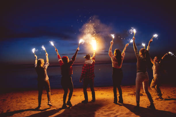 istock Group friends dusk signal fire beach 1053553168