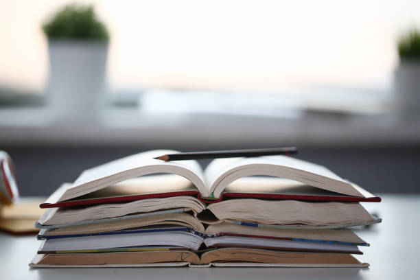 istock Books lie on the table in office at home 1053553684