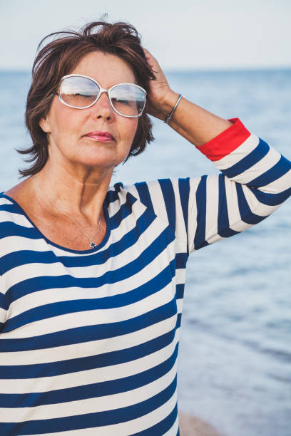 istock Pretty elderly woman on vacation at the seaside 1053553776