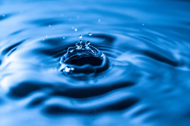 istock water drop splash in a glass blue colored 1053559404