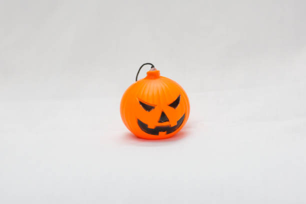 istock Rubber toy pumpkin for halloween decoration isolated on white background 1053559924
