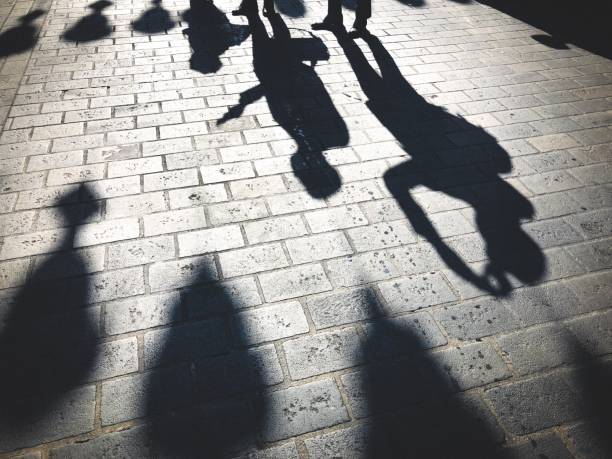 istock Shadows of People with Smartphones 1053562054