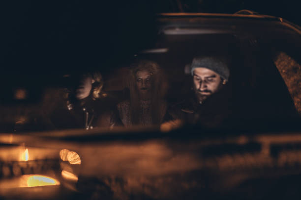 istock Couple in car with a scary witch 1053564874