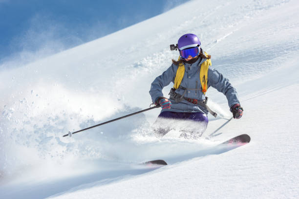 istock Female skier skiing on fresh snow 1053568108