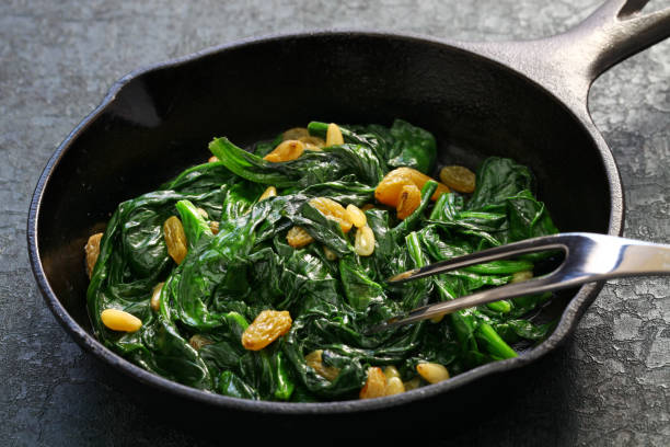 istock sauteed spinach with raisins and pine nuts, spanish catalan dish 1053568442