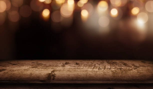 istock Christmas bokeh background and wooden table 1053572922
