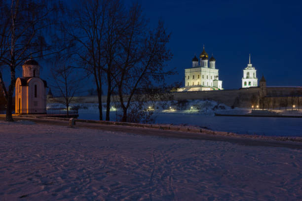 Memorial chapel of St Olga with Trinity cathedral at winter night, Russia seen across frozen river Memorial chapel of St Olga with Trinity cathedral at winter night, Russia seen across frozen river. Cathedral is a place of worship pskov city stock pictures, royalty-free photos & images