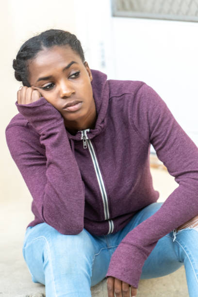 istock Serious bored beautiful young black woman 1053574876