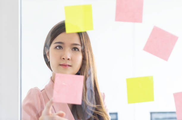 istock Cute Asian woman is planning idea on to note paper 1053586238