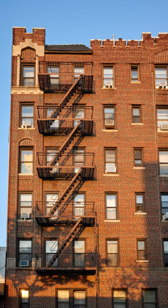 istock Old brick building with fire escapes at sunset, NYC. 1053586624