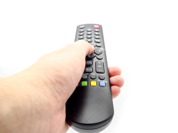 istock Hand holding a remote control TV isolated on white background. 1053587304