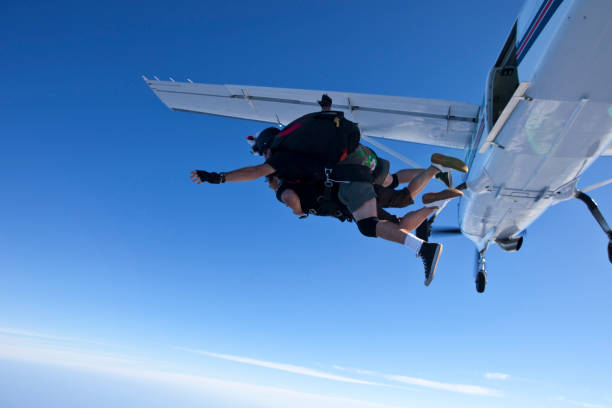 istock Sky divers launch together out of plane 1053590544