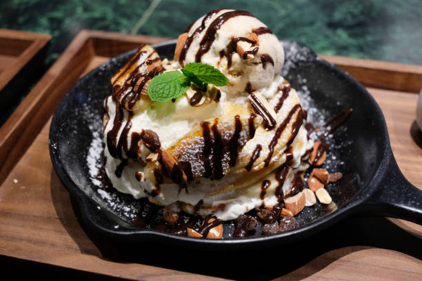 istock Caramelized Banana Pancake served with ice cream and chocolate sauce. 1053590762