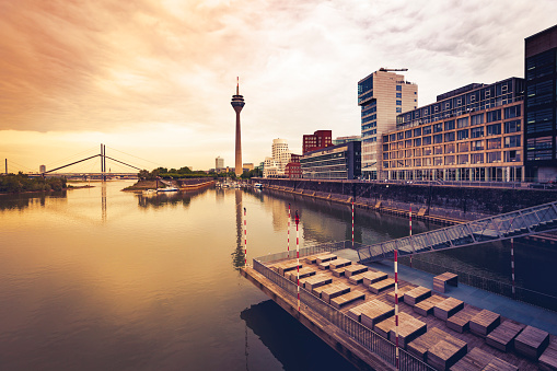 the media harbor, tv tower and rhine river in duesseldorf at sunset in germany.
