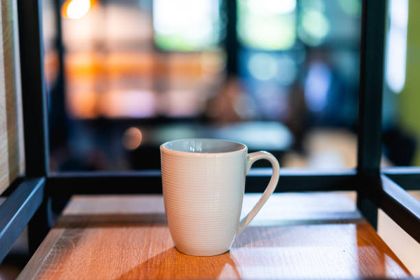 istock White coffee or tea mug on a shelf or bookcase in an office or coworking space 1053598538