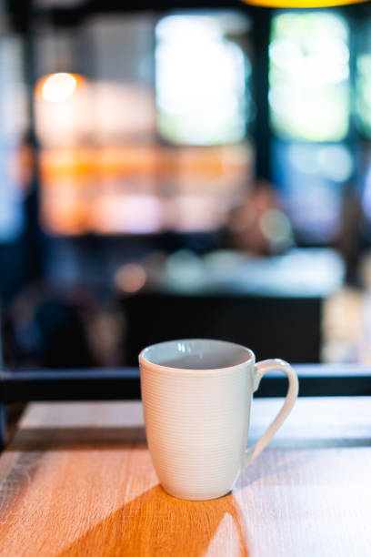 istock White coffee or tea mug on a shelf or bookcase in an office or coworking space 1053598550