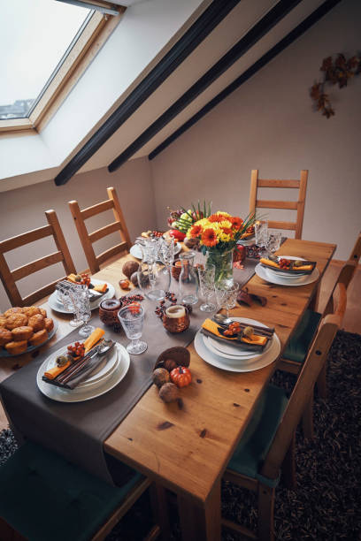 istock Decorated Table for Thanksgiving Dinner with Candles, Pumpkins, Leafs and Nuts 1053603892