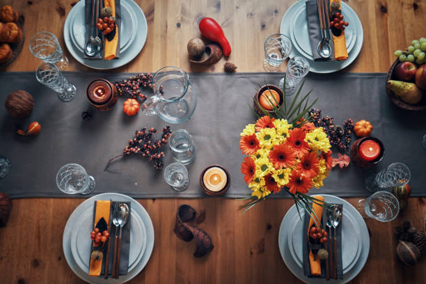 istock Decorated Table for Thanksgiving Dinner with Candles, Pumpkins, Leafs and Nuts 1053603896