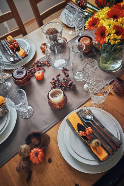 istock Decorated Table for Thanksgiving Dinner with Candles, Pumpkins, Leafs and Nuts 1053603898