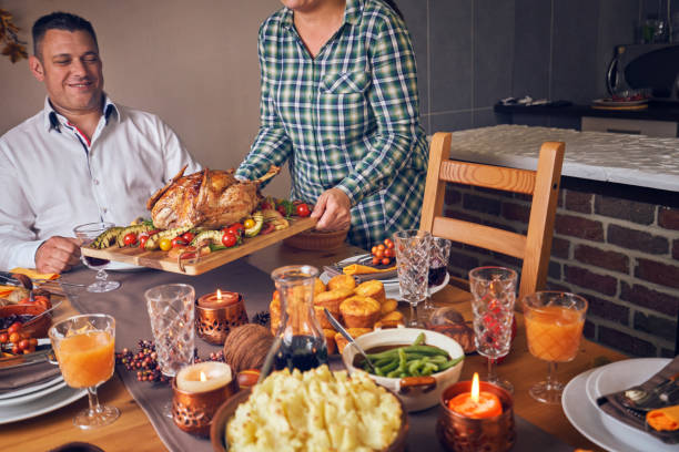 istock Family Having Traditional Holiday Stuffed Turkey Dinner 1053603958