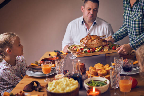 istock Family Having Traditional Holiday Stuffed Turkey Dinner 1053603964