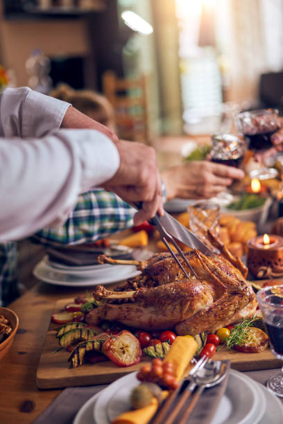 istock Family Having Traditional Holiday Stuffed Turkey Dinner 1053603974