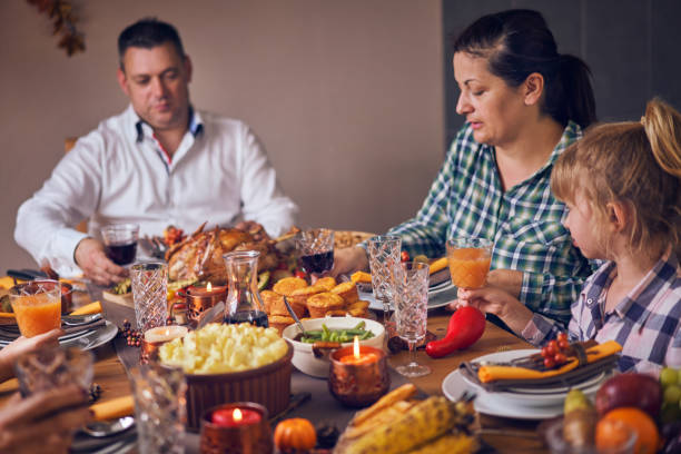 istock Family Having Traditional Holiday Stuffed Turkey Dinner 1053603976
