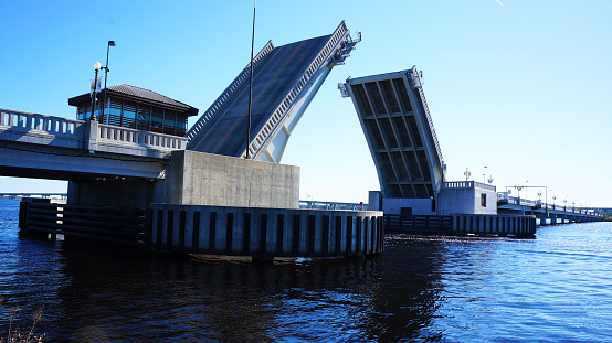 A drawbridge opening on a river.