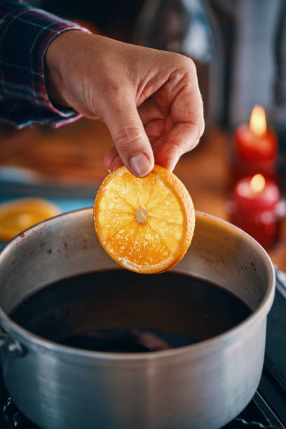 istock Preparing Mulled Wine with Orange, Cinnamon, Star Anise and Spices for Christmas 1053604450