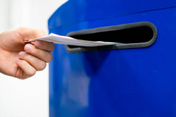istock close up hand drop letter and documents in the blue postbox in post office mail f 1053604508