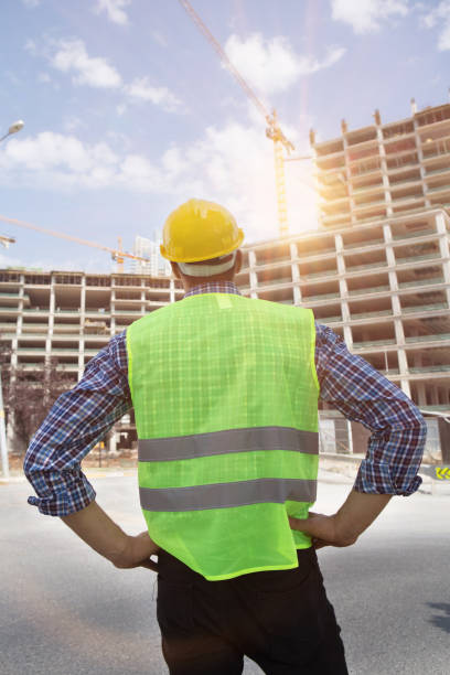 istock Young Engineer portrait with construction site and crane background. 1053611370