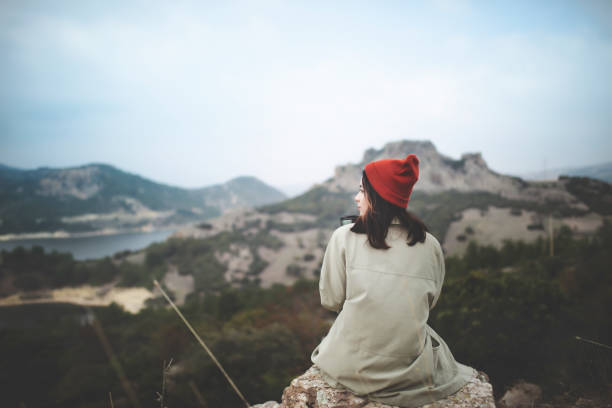 istock Pensive lonely young woman sitting alone 1053615160
