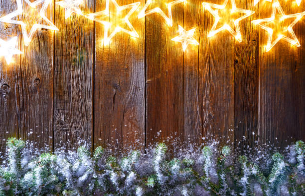 istock Christmas glowing stars and snow fir 1053616506
