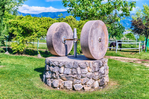 Ancient olive press with two millstones in the countryside