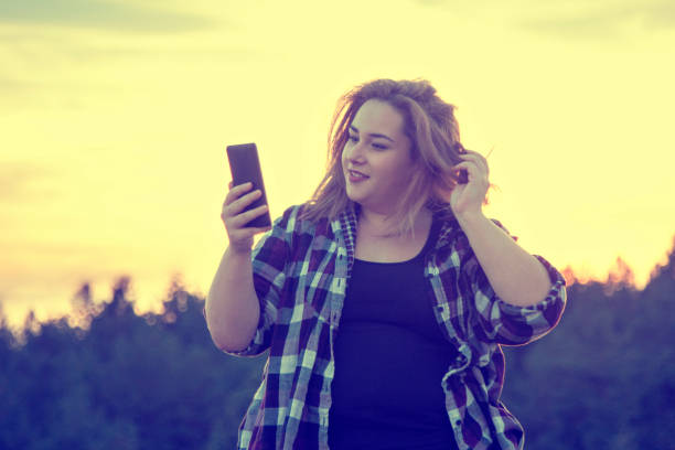istock Young woman taking a selfie in nature 1053621424