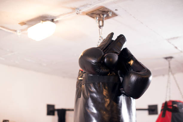 istock Boxing Glove and Punching Bag in Foreground 1053626506