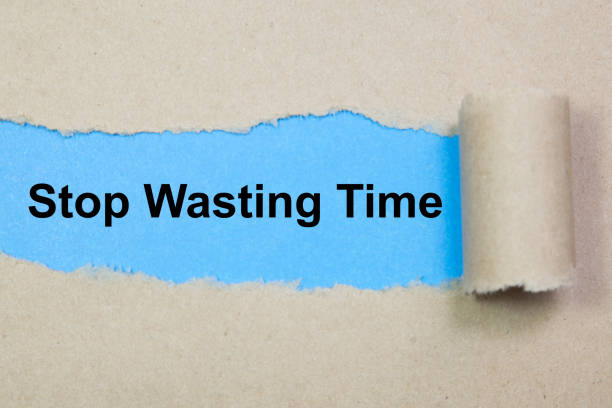 istock Stop Wasting Time text on paper. Word Stop Wasting Time on torn paper. Concept Image. 1053627070