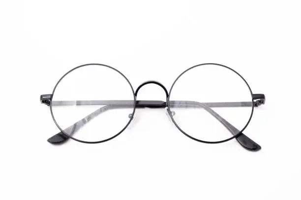 Photo of Round black-rimmed glasses are located frontally eyeglasses are folded behind