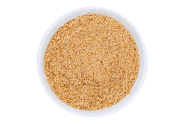 istock Brown cane sugar from above bowl isolated on white 1053636774