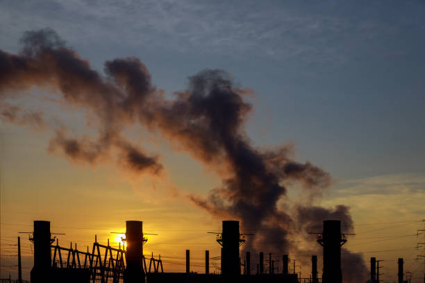 istock panorama at morning with steam from a power station 1053645186