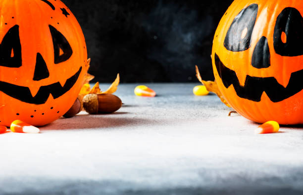 istock Halloween composition with pumpkins lanterns, with smoke and fallen leaves 1053648096