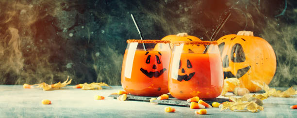 istock Halloween composition with festive red bloody drink and smiling pumpkins 1053648162