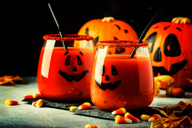 istock Halloween composition with festive red bloody drink and smiling pumpkins 1053648178