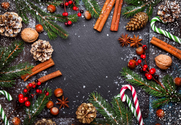 istock Christmas or New Year dark background, frame, template, with festive decorations, winter spices and Christmas decorations 1053649788