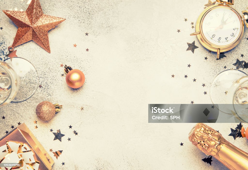 Christmas or New Year composition, gray background with gold Christmas decorations Christmas or New Year composition, gray background with gold Christmas decorations, stars, snowflakes, balls, alarm clock, gift box, top view New Year Stock Photo