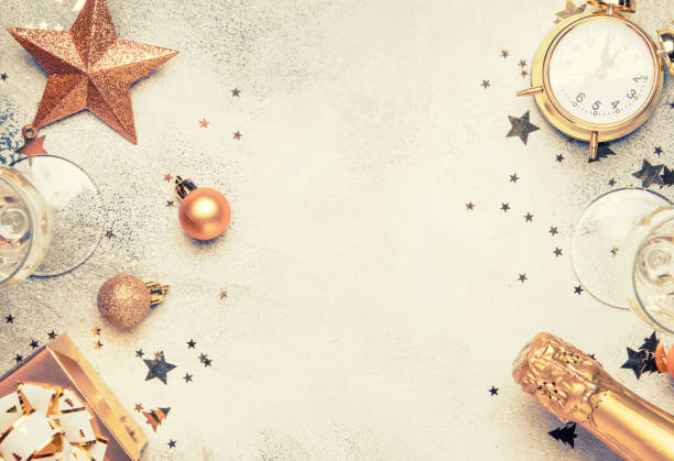 Christmas or New Year composition, gray background with gold Christmas decorations Christmas or New Year composition, gray background with gold Christmas decorations, stars, snowflakes, balls, alarm clock, gift box, top view new years 2019 stock pictures, royalty-free photos & images