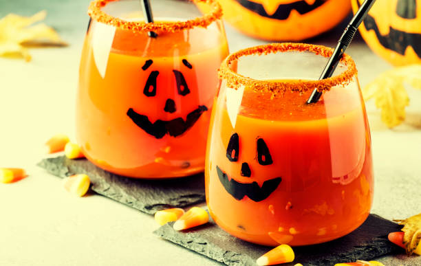 istock Halloween composition with festive red bloody drink and smiling pumpkins 1053650384