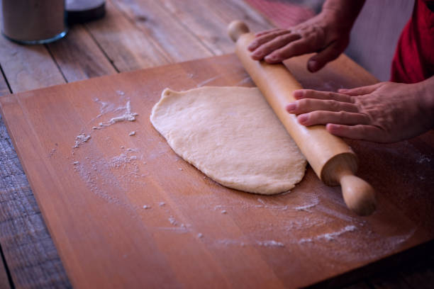 istock Thanksgiving dining, pumpkin pie making, kneading dough 1053658240