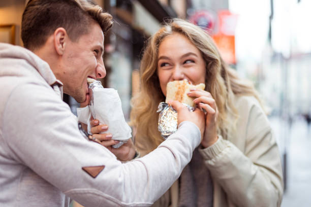 istock Young couple eating fast food 1053658540